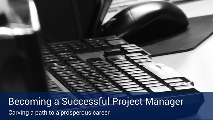A poster that says "becoming a successful project manager" with a black keyboard in the background.