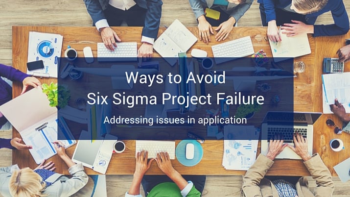 A table full of people sitting around it with office supplies, computers, and coffee scattered around the table with a blue banner at the bottom of the image that reads "Ways to Avoid Six Sigma Project Failure".