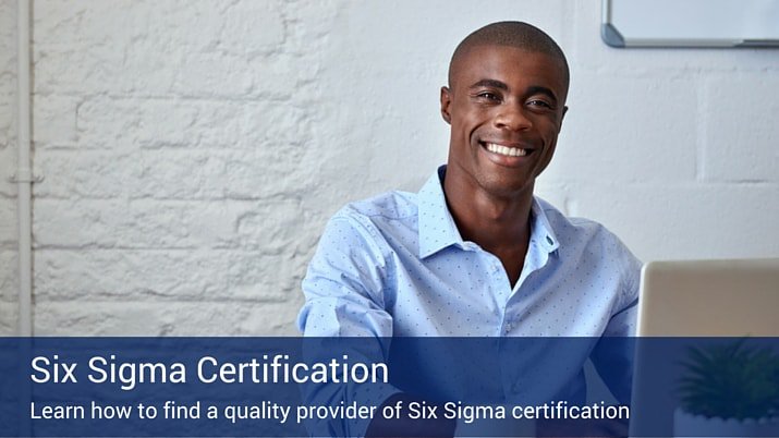 A man on his laptop looking into the camera, while earning his six sigma certification..