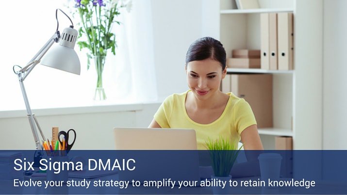 A woman sitting at a desk with a lamp and a cup of pencils working on her laptop, learning about DMAIC.