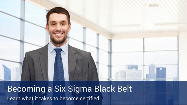 A man in a suit and tie smiling into the camera with a blue banner that says "Becoming a six sigma black belt" on the bottom of the photo.