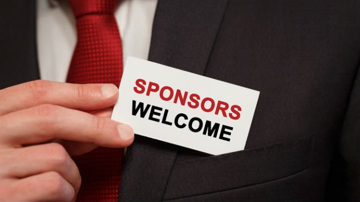 Executive sponsor depicted as a man holding a small business car that reads "SPONSORS WELCOME" that he is putting into his suit pocket.