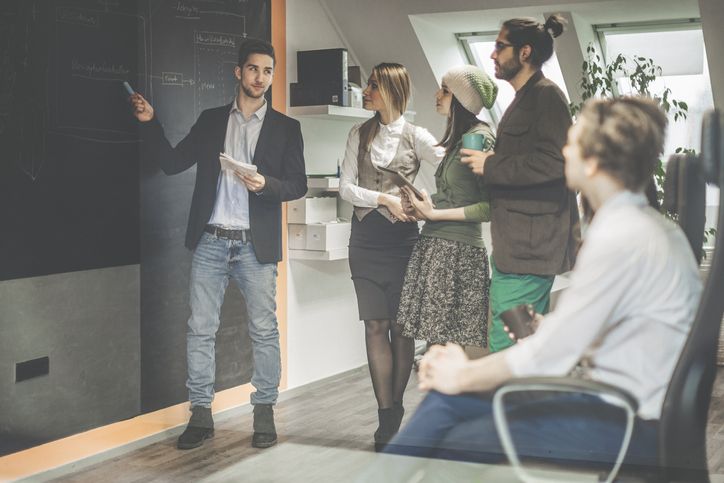 An Agile Product Owner leads a standup meeting with their Agile team