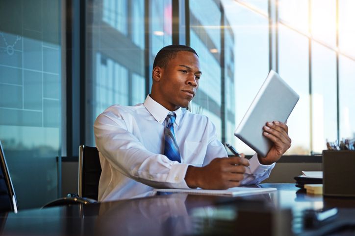 Business professional looks over the details of a contract before signing it.