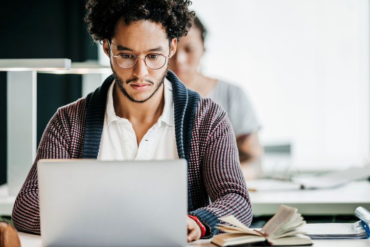 African American male concentrating on a laptop