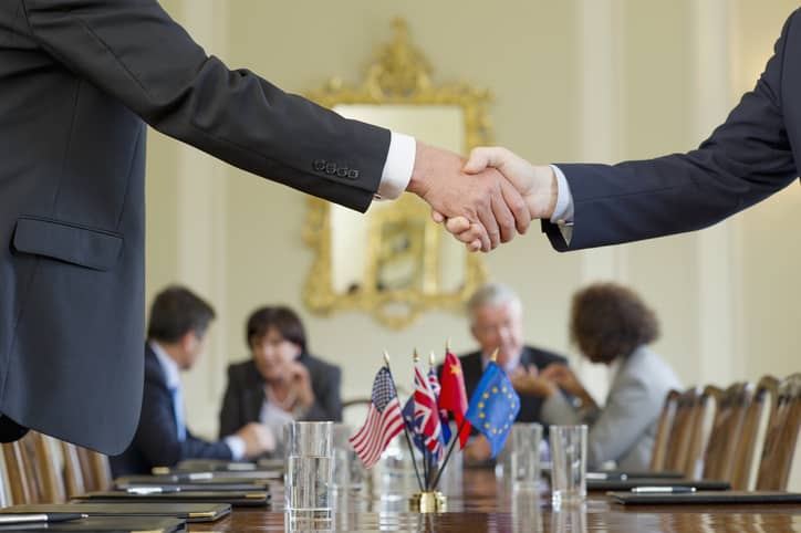 Public administrators shaking hands in meeting