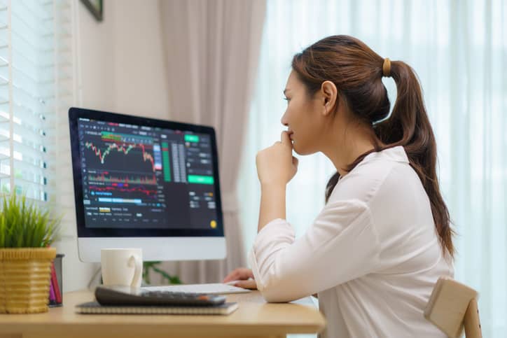 Businesswoman working from home on desktop looking at data